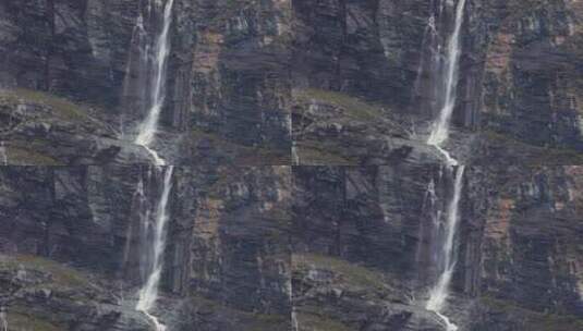 川西稻城仙乃日神山瀑布流水飞溅直下远景高清在线视频素材下载