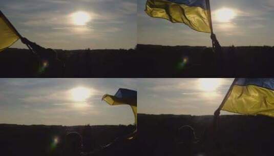 乌克兰军人站在山上挥舞国旗对抗日落男兵的高清在线视频素材下载