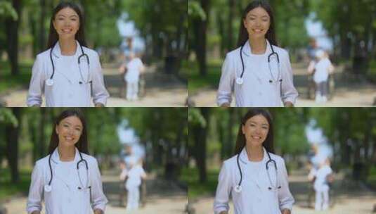 康复中心附近公园里微笑的女医生看着摄像机高清在线视频素材下载