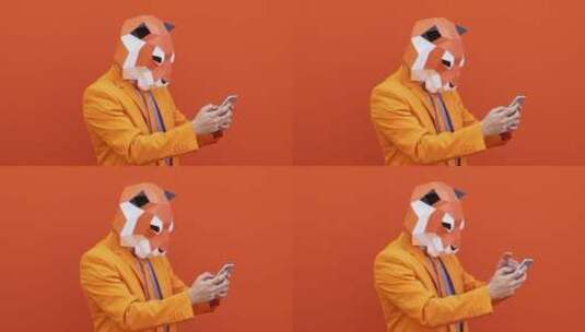 带着面具的人在玩手机高清在线视频素材下载