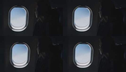 女人坐飞机望向窗外高清在线视频素材下载