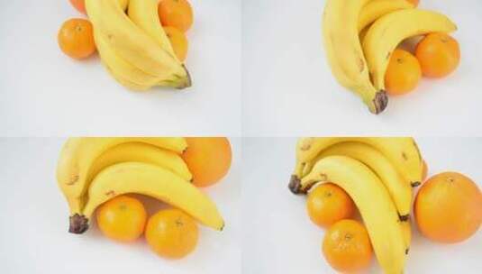 白色表面的香蕉和橘子高清在线视频素材下载