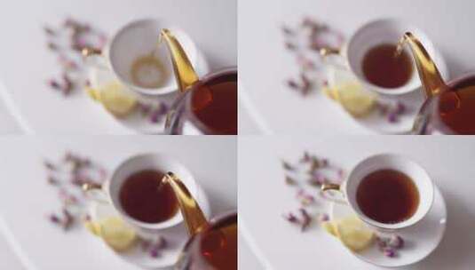 茶壶倒茶入瓷杯的俯视图高清在线视频素材下载