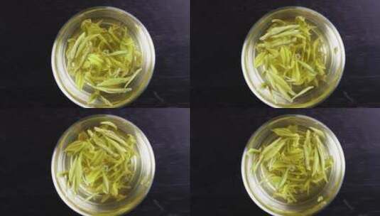 泡茶叶在透明玻璃茶杯中旋转高清在线视频素材下载