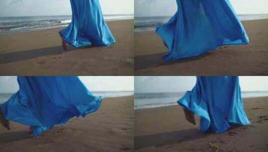 穿着蓝色裙子在海滩散步的女性高清在线视频素材下载