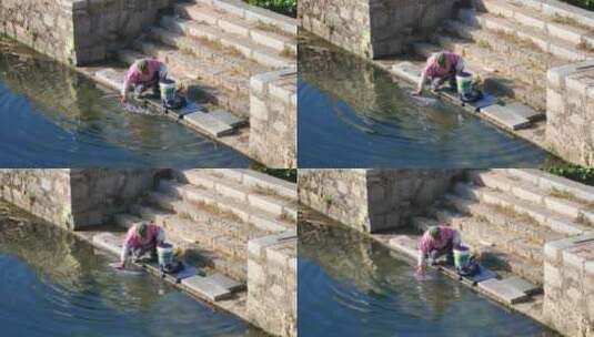 一个老人在河边洗衣服高清在线视频素材下载