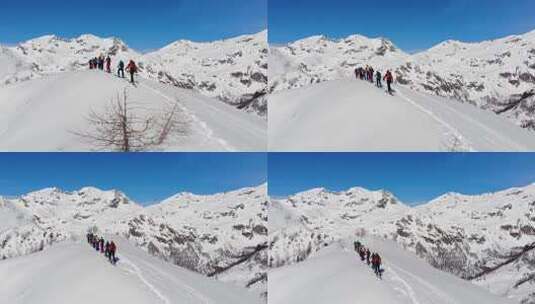 一组滑雪旅游在皮肤上坡排成一行。在大山里滑雪旅游高清在线视频素材下载