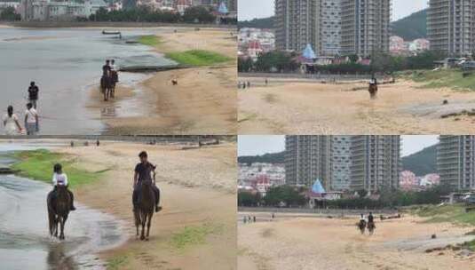 航拍威海市环翠区金海路沙滩上的骑马人高清在线视频素材下载