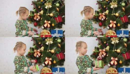 女孩在圣诞树下挑选礼物高清在线视频素材下载