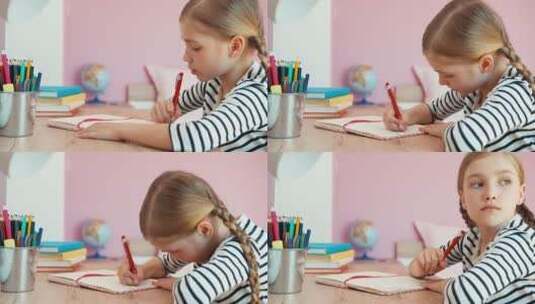 女孩坐在桌前做作业高清在线视频素材下载
