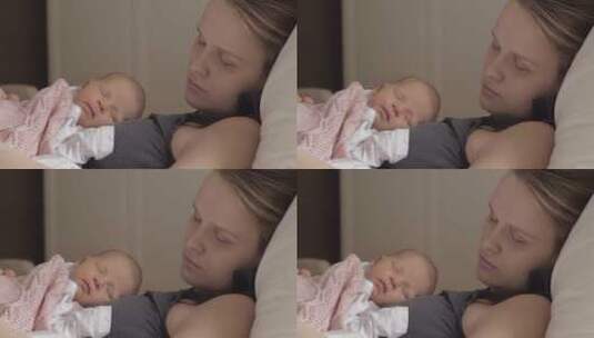 母亲和婴儿在床上睡觉高清在线视频素材下载