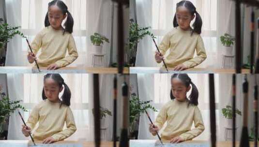 练习毛笔字的亚洲女孩高清在线视频素材下载
