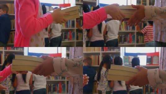 女学生在学校图书馆给女老师一本书4k高清在线视频素材下载