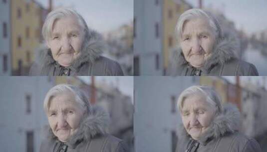 穿着毛皮大衣的老妇人在天空下微笑，脸上有高清在线视频素材下载