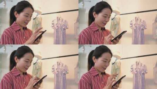 亚洲东方中国女性在商场内挑选衣服购物高清在线视频素材下载