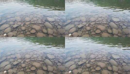 鹅卵石清澈水面随微风缓缓流淌背景高清在线视频素材下载