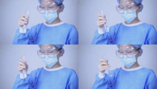 穿着一次性手术服的医生手持检验样品高清在线视频素材下载