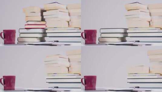 桌子上一堆书的定格镜头高清在线视频素材下载