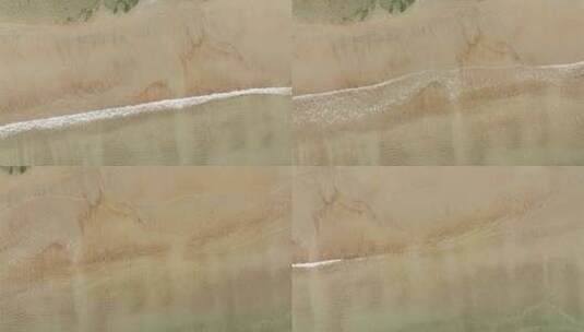 航拍俯瞰威海市环翠区金海路沙滩上的海浪花高清在线视频素材下载