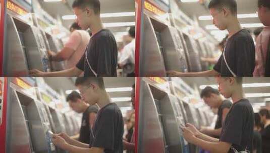 男孩在地铁站自助设备购买地铁票高清在线视频素材下载