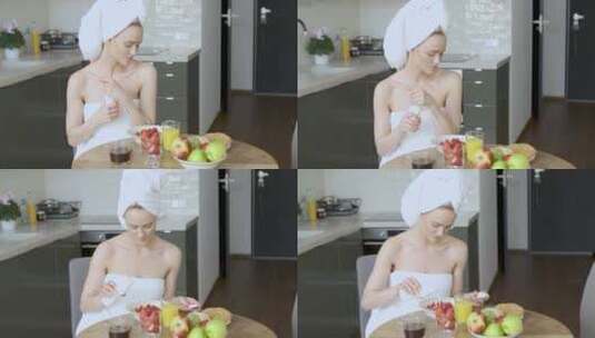 洗澡后在厨房吃早饭的精致女子高清在线视频素材下载