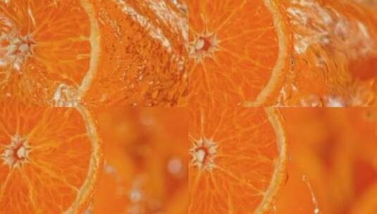旋转橘子片泼水的超慢动作镜头高清在线视频素材下载