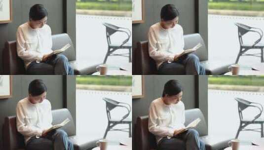青年女性坐在咖啡馆看书高清在线视频素材下载