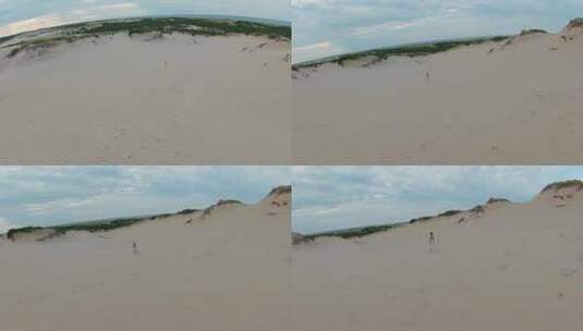 鸟瞰沙漠景观，跟随一个女孩在高沙丘上奔跑高清在线视频素材下载
