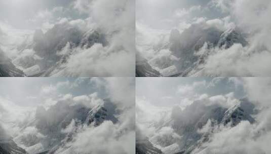 巍峨山峰山脉山峦航拍阳光下的雪山云雾云霄高清在线视频素材下载