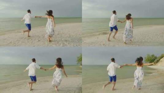 情侣手牵手在沙滩上奔跑高清在线视频素材下载