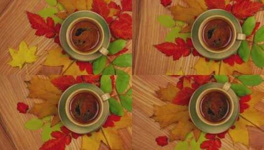 木桌上一杯咖啡旁放着几片秋天的树叶高清在线视频素材下载