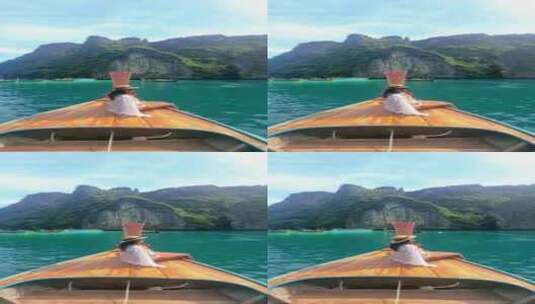 一个女人坐在水上的船背上玛雅湾皮皮岛泰国高清在线视频素材下载