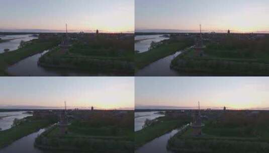 荷兰日落时风车和河流的鸟瞰图。高清在线视频素材下载