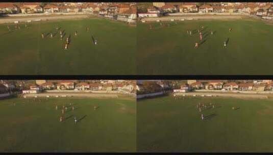 航拍人们在操场上踢足球景观高清在线视频素材下载