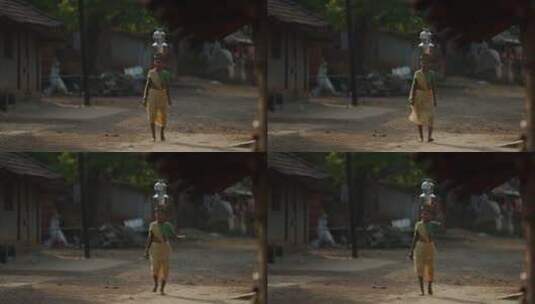 头顶瓦罐行走的印度女孩高清在线视频素材下载