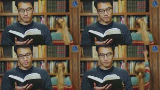 戴眼镜的男人在图书馆看书高清在线视频素材下载