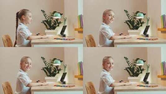 女孩坐在书桌前看着镜头微笑高清在线视频素材下载