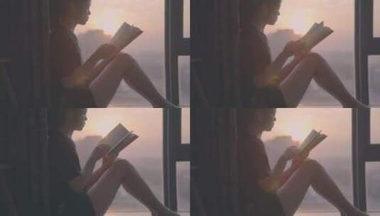 女孩坐在落地窗前看书，唯美窗边夕阳高清在线视频素材下载