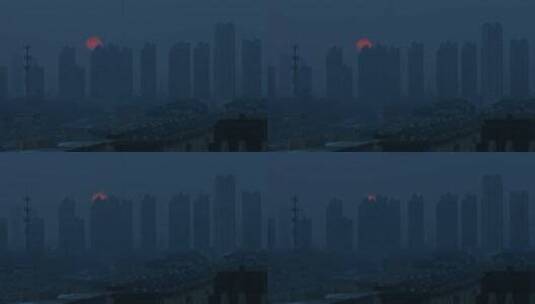 冬季城市夕阳红日落幕雾霾下的高层建筑小区高清在线视频素材下载
