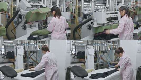 服装厂车间工人正在熨烫衣物高清在线视频素材下载