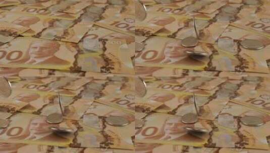 100美元聚合物纸币上掉落的加拿大硬币，上面有罗伯特·博登的肖像。慢动作高清在线视频素材下载