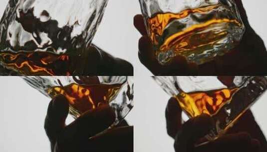 玻璃酒杯里的威士忌金黄色酒液摇晃高清在线视频素材下载