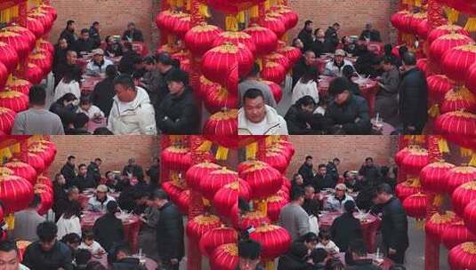 人群围坐红灯笼下聚餐场景高清在线视频素材下载