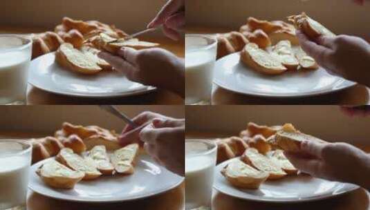 在一片面包上抹上黄油。健康的早餐和牛奶高清在线视频素材下载