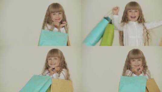 快乐的小女孩拿着彩色的纸袋高清在线视频素材下载
