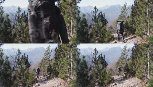 一个男人背着包步行在崎岖山路高清在线视频素材下载