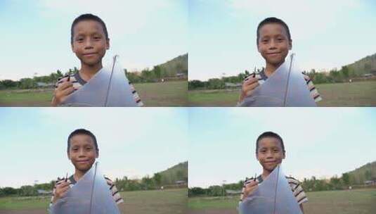 拿着风筝微笑的男孩特写镜头高清在线视频素材下载