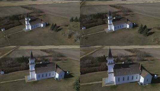 无人机接近坐落在北美草原景观中的美丽古老遗产教堂高清在线视频素材下载