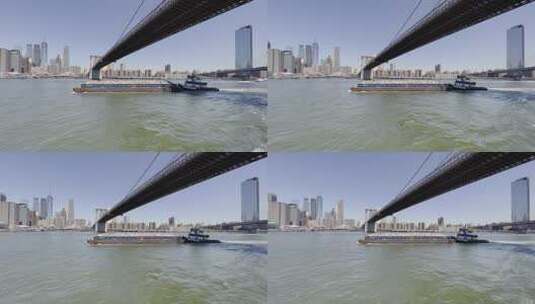 纽约布鲁克林大桥驳船和拖船固体废物管理；空中高清在线视频素材下载