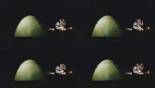 情侣露营晚上在篝火旁高清在线视频素材下载